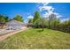 Expansive backyard featuring lush green grass, mature trees, privacy fence and detached garage at 7340 W 32Nd Ave, Wheat Ridge, CO 80033