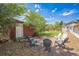 A quaint backyard featuring a gravel area, a well-manicured lawn, an outbuilding, and comfortable outdoor seating at 7340 W 32Nd Ave, Wheat Ridge, CO 80033