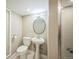 Bathroom boasts updated lighting, fixtures, pedestal sink and tile flooring at 7340 W 32Nd Ave, Wheat Ridge, CO 80033