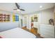 Bedroom featuring a ceiling fan, hardwood floors, and closet storage at 7340 W 32Nd Ave, Wheat Ridge, CO 80033