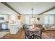 Cozy dining area adjacent to a modern kitchen with white cabinets at 7340 W 32Nd Ave, Wheat Ridge, CO 80033
