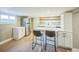 Basement kitchen featuring an island with seating and stainless steel appliances at 7340 W 32Nd Ave, Wheat Ridge, CO 80033