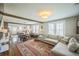 Open-concept living room featuring hardwood floors and exposed beam at 7340 W 32Nd Ave, Wheat Ridge, CO 80033