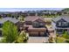 Aerial view of a two-story home with a three-car garage and well-manicured landscaping at 7514 Blue Water Dr, Castle Rock, CO 80108