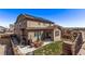 Spacious backyard featuring a patio with dining set, grill, and well-maintained lawn at 7514 Blue Water Dr, Castle Rock, CO 80108
