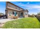 Backyard featuring a patio seating area, lush grass, retaining wall, and ample space at 7514 Blue Water Dr, Castle Rock, CO 80108