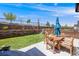 Well-maintained backyard with patio, retaining wall, landscaping and seating area at 7514 Blue Water Dr, Castle Rock, CO 80108