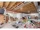 Unfinished basement area with exposed ceiling and support beams, storage, and an egress window at 7514 Blue Water Dr, Castle Rock, CO 80108