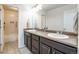Well-lit bathroom with a double vanity and a tub-shower combo providing a bright and functional space at 7514 Blue Water Dr, Castle Rock, CO 80108