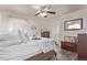 Inviting bedroom with a ceiling fan, hardwood floors, and floral-patterned accents at 7514 Blue Water Dr, Castle Rock, CO 80108