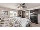 Comfortable bedroom with a window view, ceiling fan, and ensuite bath at 7514 Blue Water Dr, Castle Rock, CO 80108