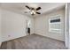 Well-lit room features neutral walls and carpet with ceiling fan and view into the adjoining bathroom at 7514 Blue Water Dr, Castle Rock, CO 80108