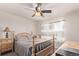 Bright bedroom featuring a ceiling fan, wooden accents, and window view at 7514 Blue Water Dr, Castle Rock, CO 80108