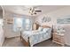 Bright bedroom featuring a ceiling fan, blue accents, and carpeted floors at 7514 Blue Water Dr, Castle Rock, CO 80108