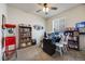 Bedroom featuring a home office setup, built-in bookshelves, and natural light at 7514 Blue Water Dr, Castle Rock, CO 80108