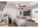 A cozy bedroom with a ceiling fan, drawers and a TV mounted in the upper corner of the room at 7514 Blue Water Dr, Castle Rock, CO 80108