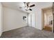 Neutral bedroom featuring neutral carpet, a ceiling fan, and a window providing natural light, creating a relaxing space at 7514 Blue Water Dr, Castle Rock, CO 80108