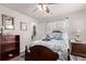 Charming bedroom with wood accents, decorative linens, and a ceiling fan at 7514 Blue Water Dr, Castle Rock, CO 80108