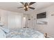 Cozy bedroom features a ceiling fan, beach decor, and an ensuite bath at 7514 Blue Water Dr, Castle Rock, CO 80108