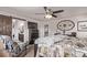 Spacious bedroom featuring a ceiling fan, dark wood furniture, and an ensuite bathroom at 7514 Blue Water Dr, Castle Rock, CO 80108