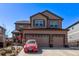 Two-story home featuring a two-car garage, neutral siding, well-kept landscaping, and covered entry at 7514 Blue Water Dr, Castle Rock, CO 80108