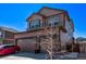 Two-story home with neutral siding, a two-car garage, professional landscaping and manicured lawn at 7514 Blue Water Dr, Castle Rock, CO 80108