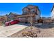 Two-story home with neutral siding, a two-car garage and simple landscaping with rocks and bushes at 7514 Blue Water Dr, Castle Rock, CO 80108