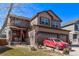 Two-story home featuring a two-car garage, neutral siding, well-kept landscaping, and covered entry at 7514 Blue Water Dr, Castle Rock, CO 80108