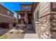 Charming two-story house with stone accents, covered porch, manicured yard and walkway leading to the front door at 7514 Blue Water Dr, Castle Rock, CO 80108