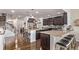 Open concept kitchen with dark cabinets, stainless steel appliances, and bar stool seating at 7514 Blue Water Dr, Castle Rock, CO 80108