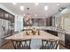 Modern kitchen island with granite countertop and seating, next to stainless appliances at 7514 Blue Water Dr, Castle Rock, CO 80108