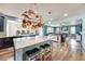 Bright and spacious kitchen with an island open to the living room area with a fireplace at 7514 Blue Water Dr, Castle Rock, CO 80108