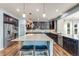 Modern kitchen featuring granite countertops, wood flooring, stainless steel appliances and large island with seating at 7514 Blue Water Dr, Castle Rock, CO 80108