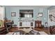 Cozy living room with wooden floors, soft blue walls, and modern entertainment center at 7514 Blue Water Dr, Castle Rock, CO 80108