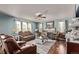 Cozy living room with a fireplace, comfortable seating, and plenty of natural light at 7514 Blue Water Dr, Castle Rock, CO 80108