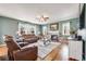 Cozy living room featuring a fireplace, hardwood floors, and plush leather seating at 7514 Blue Water Dr, Castle Rock, CO 80108