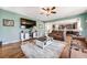 Comfortable open-concept living room, seamlessly connected to the kitchen space with hardwood flooring at 7514 Blue Water Dr, Castle Rock, CO 80108