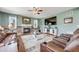 Comfortable living room with hardwood floors, fireplace, ceiling fan, large screen TV and leather furniture at 7514 Blue Water Dr, Castle Rock, CO 80108