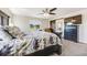Spacious bedroom with a ceiling fan, dark wood accents, and large window offering bright natural light at 7514 Blue Water Dr, Castle Rock, CO 80108