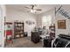 Well lit office featuring large windows, a ceiling fan, books, a desk, and two chairs at 7514 Blue Water Dr, Castle Rock, CO 80108