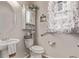 Charming powder room with pedestal sink, floral curtain, and decorative touches at 7514 Blue Water Dr, Castle Rock, CO 80108