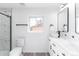 Modern bathroom with dual sinks, sleek fixtures, and a glass-enclosed shower creates a spa-like experience at 4164 W Eldorado Pl, Denver, CO 80236