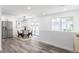 Bright dining room with modern light fixture and open access to the patio at 4164 W Eldorado Pl, Denver, CO 80236