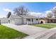 Well-manicured lawn and wide driveway leading to a delightful single-story home at 4164 W Eldorado Pl, Denver, CO 80236