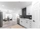 Open concept kitchen with stainless steel appliances, white cabinets, dining area, and modern design at 4164 W Eldorado Pl, Denver, CO 80236
