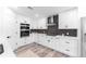 Stylish kitchen with white cabinets, subway tile backsplash, stainless steel appliances, and modern fixtures at 4164 W Eldorado Pl, Denver, CO 80236