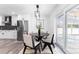 Modern eat-in kitchen with stainless steel appliances, breakfast nook, and access to the sunroom at 4164 W Eldorado Pl, Denver, CO 80236