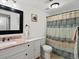 Updated bathroom with a modern vanity, framed mirror, and tiled shower-tub combination at 7665 E Eastman Ave # 110, Denver, CO 80231