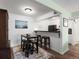 Eat-in kitchen dining area with breakfast bar and modern lighting at 7665 E Eastman Ave # 110, Denver, CO 80231