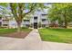 Well-maintained apartment building with lush landscaping and inviting walkway at 7665 E Eastman Ave # 110, Denver, CO 80231